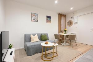 a living room with a couch and a table at Résidence Sébastopol - Appartements Hyper Centre - WiFi & Smart TV in Béziers +63 photos