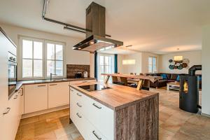 a kitchen and living room with a table in the background at Kramerhof Rügenblick Nr 30 in Parow