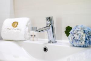 a bathroom sink with a faucet and a towel at GuestReady - Passal Guesthouse in Ponta Delgada