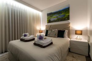 a bedroom with a large white bed with two pillows at GuestReady - Passal Guesthouse in Ponta Delgada