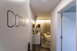 a hotel room with a door leading to a bedroom at GuestReady - Passal Guesthouse in Ponta Delgada