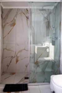 a bathroom with a glass shower with a sink at Best House Erato Neo Faliro Piraeus in Piraeus +13 photos