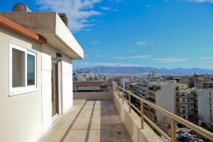 a balcony with a view of a city at Best House Erato Neo Faliro Piraeus in Piraeus