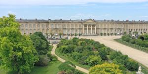 a large palace with trees in front of it at Appartement proche Château de Compiègne in Compiègne +5 photos
