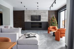 a living room with a christmas tree and a fireplace at Gogodz Chalet Resort in Yablunytsya