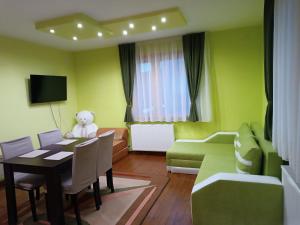 a living room with a teddy bear sitting at a table at Guest House Марковата Къща in Madzhare