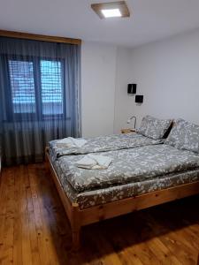 a bedroom with a bed and a window at Guest House Марковата Къща in Madzhare