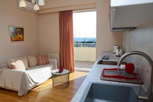 a kitchen and living room with a couch and a sink at Best House Penelope Neo Faliro Piraeus in Piraeus