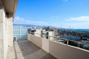 a balcony with a view of a city at Best House Penelope Neo Faliro Piraeus in Piraeus