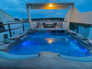 a jacuzzi tub on a cruise ship at night at Hausboot Pula - Floating House Water Lily in Pula