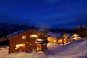 a log cabin in the snow at night at Chalet Torstein in Schladming