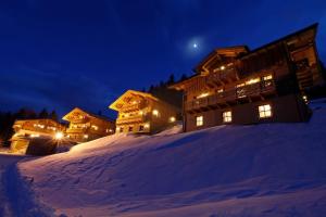 a ski lodge in the snow at night at Chalet Torstein in Schladming