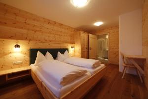 a bedroom with a large bed in a wooden room at Chalet Torstein in Schladming