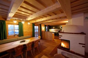 a living room with a fireplace and a table and chairs at Chalet Torstein in Schladming