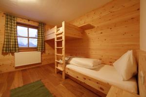 a log cabin with a bunk bed and a ladder at Chalet Torstein in Schladming +5 photos