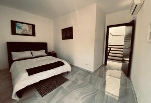 a bedroom with a bed and a door to a balcony at Coraçon di Mindel Apartment in Mindelo