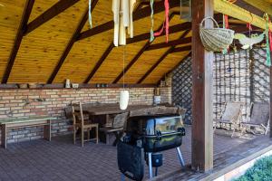 a screened in porch with a table and chairs at Halinówka Goniądz in Goniadz