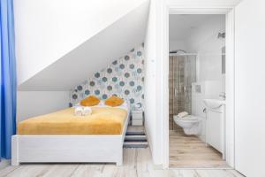 a white bedroom with a bed and a bathroom at Halinówka Goniądz in Goniadz +56 photos