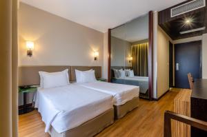 a bedroom with a large white bed and a bathroom at TURIM Santa Maria da Feira Hotel in Santa Maria Da Feira +52 photos