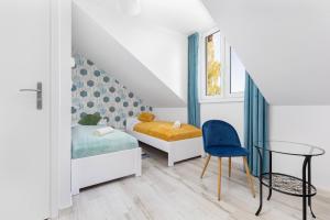 a bedroom with a bed and a table and a chair at Halinówka Goniądz in Goniadz