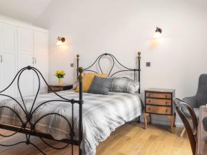 a bedroom with a bed and a table and a chair at Mill House Barn in Warmingham +15 photos