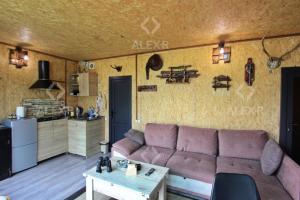 a living room with a couch and a kitchen at Full Panorama Guest House in Aparan +5 photos