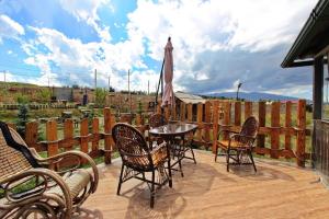 a patio with chairs and a table and an umbrella at Full Panorama Guest House in Aparan