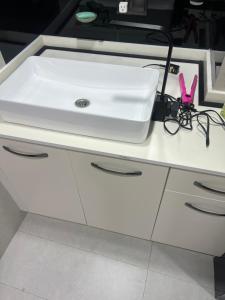 a white bathroom sink sitting on top of a counter at pasanauri gudauri in Passanauri +5 photos