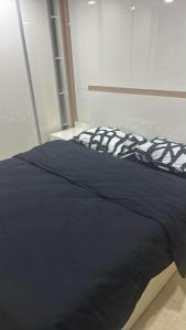 a bed with a black comforter in a room at pasanauri gudauri in Passanauri