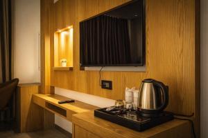 a hotel room with a coffee maker and a tv at Hotel Rs Vista - Agra in Agra