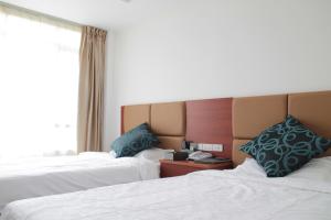 a hotel room with two beds and a window at Z.H.P Hotel in Ban Khlong Nung +8 photos