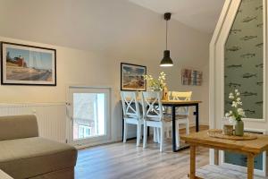 a living room with a table and a chair at Ole in Borgsum in Borgsum