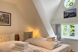 a bedroom with two beds and a window at Ole in Borgsum in Borgsum +15 photos