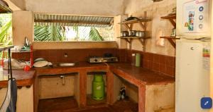 a small kitchen with a sink and a window at Wildebeeste Lamu in Lamu