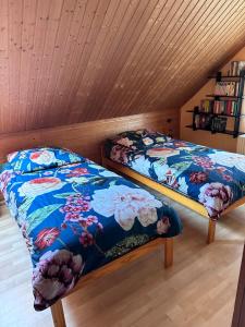 two beds in a room with a wooden ceiling at Apel Apartments 1 in Nörten-Hardenberg