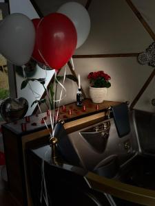 a room with balloons and a table with a sink at Ghadi Domes in Nimrod