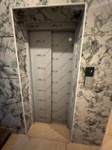a room with a closet with a door that has dividers at ars inn and mini hall in Tiruvallam