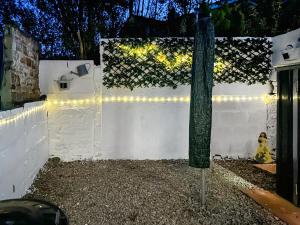 a white fence with lights and a yellow fire hydrant at Miner's Rest in Frizington
