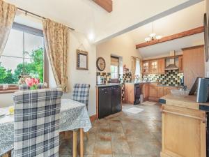 a kitchen with a table and chairs in a room at Beckside in Gilcrux