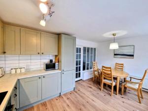 a kitchen and dining room with a table and chairs at Central modern home with parking in Nantwich