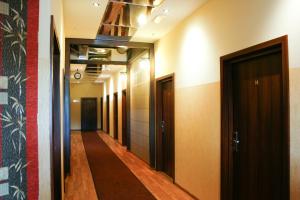 a corridor of a hallway with doors and a hallway at Hotel 7 in Szczecin
