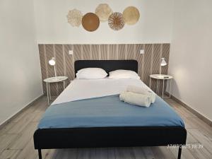 a bedroom with a large bed with two tables at Blife Montya private rooms in Faro