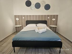 a bedroom with a bed with two towels on it at Blife Montya private rooms in Faro