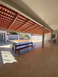 a patio with a ping pong table under awning at Casa Jabuticabeira in Manhã