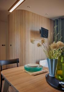 a wooden table with a vase on top of it at U Pinarellu in Zonza