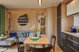 a kitchen and living room with a table and a couch at U Pinarellu in Zonza