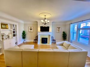 a living room with a couch and a fireplace at The Sealy Residence in Saint John