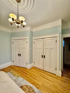 a room with white cabinets and a chandelier at The Sealy Residence in Saint John