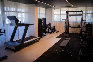 a gym with several tread machines in a room at Studio Completo Perto Hospital e Shopping in Tubarão