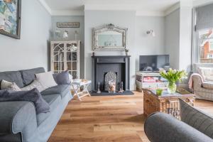 a living room with a couch and a fireplace at Danes House 4 in Aldeburgh